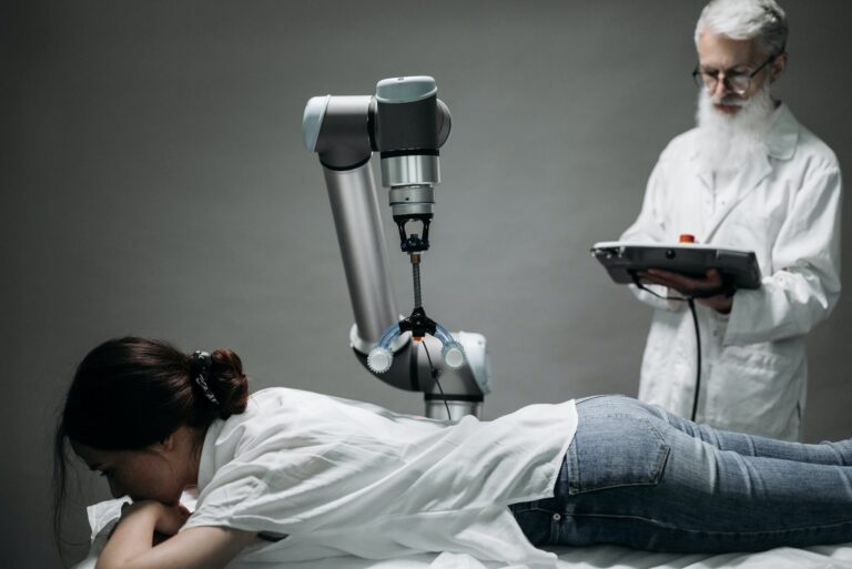 woman lying on a massage table and getting treated by a robot